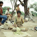 Wichí woman beating cactus fibres to make string, Argentina. &copy; Survival International
