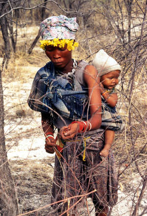 A Bushman mother and child gathering berries in the Central Kalahari Game Reserve.