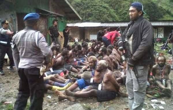 Papuan villagers were stripped to their waists and had their hands tied behind their backs before being interrogated by police.