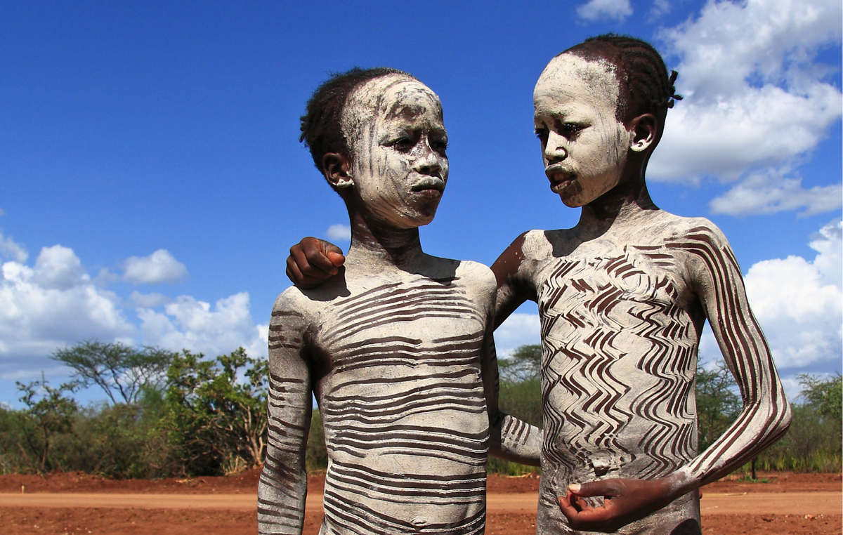Young Hamar boys painted with white ash, Omo Valley, Ethiopia. The Gibe III dam that is being constructed will destroy their people's livelihood.