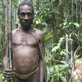 Korowai hunter with bows and arrows, West Papua. &copy; Survival International