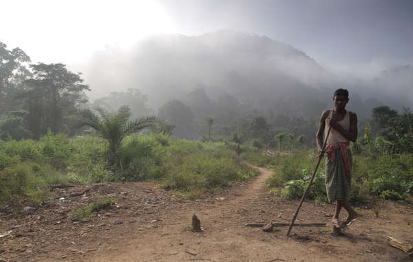 Dongria Kondh boy, Kalia, stands in front of the Niyamgiri hill range.