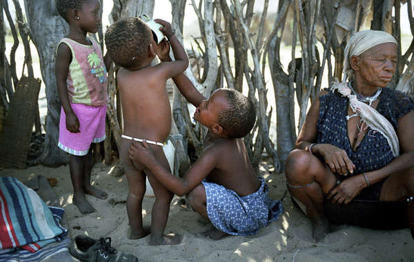 Young children drink water from a distant borehole in Metsiameneng. The Bushmen have since won a court appeal to access water on their ancestral lands.