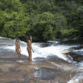 Zo'é children play in waterfall after gathering wild pineapples. &copy; Fiona Watson/Survival