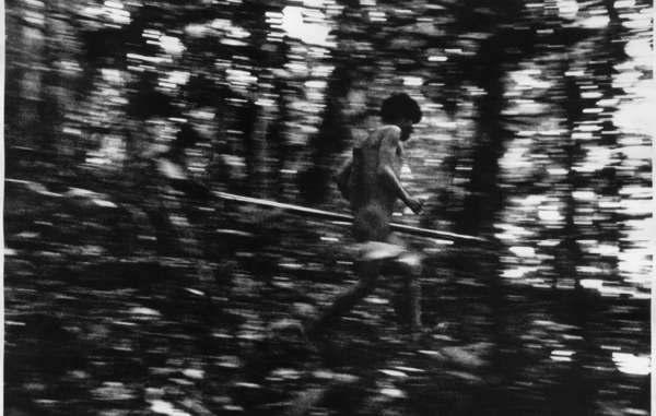 Yanomami hunter darts quietly through the Amazon, Brazil.