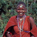 Maasai girl wearing typical red shawl and bead jewellery, Kenya. &copy; Survival International
