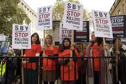 Dozens of protesters gathered outside Downing Street to mark the visit of Indonesia's President to the UK