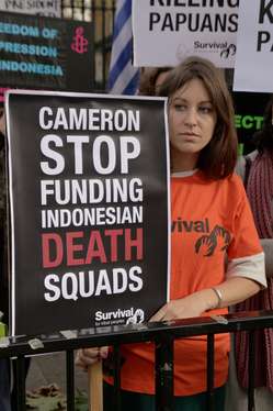 Protester holding banner reading ‘Cameron stop funding Indonesian death squads’ to mark the visit of Indonesia's President to the UK.