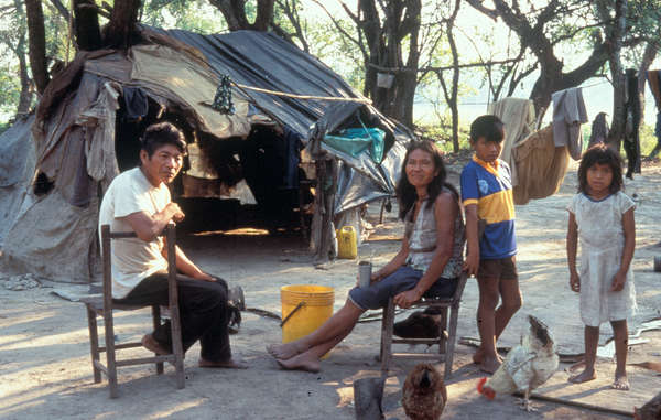 Many Enxet families have been forces to live by the sides of roads in makeshift housing for decades.