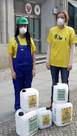 Protesters in Berlin wearing masks and helmets to symbolize the lethal effects of the Camisea project on Peru's uncontacted tribes.