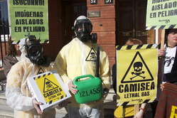 Protesters in London wearing gas masks and carrying placards to symbolize the lethal effects of the Camisea project on Peru's uncontacted tribes.