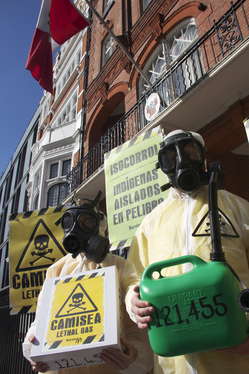 Protesters in London wearing gas masks and carrying placards to symbolize the lethal effects of the Camisea project on Peru's uncontacted tribes.