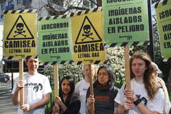 Protesters in London carrying placards to symbolize the lethal effects of the Camisea project on Peru's uncontacted tribes.