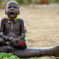 Niño nyangatom bostezando. &copy; Eric Lafforgue/Survival