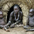 The Karo (or Kara), with a population of about 1000 - 1500 live on the east banks of the Omo River in south Ethiopia. Here, a Karo mother sits with her children. © Eric Lafforgue/Survival