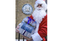 Santa Claus delivers a bottle of water to the Botswana High Com