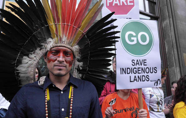 Wearing his traditional headdress and facial decoration, Nixiwaka led a protest against Brazil's assault on indigenous rights in London in October 2013.