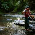 A Jumma woman washes in a stream. &copy; <span class="caps">GMB</span> Akash/Survival