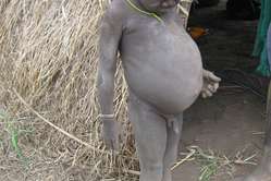 A Kwegu boy outside his hut. The Omo Valley tribes are finding it hard to feed their children in these times of drought.