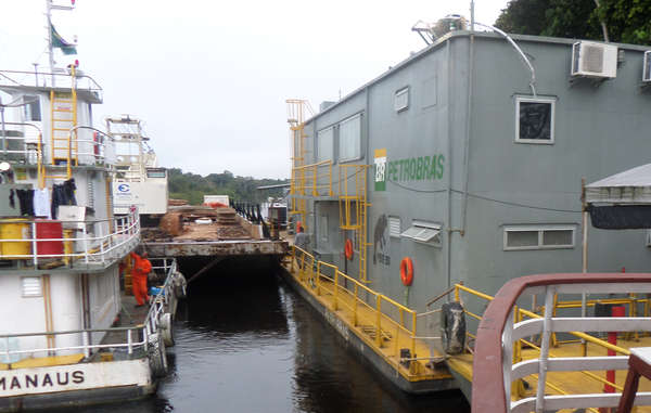 Oil exploration barges photographed last week moving into position on the Tapauá River, Amazonas state, Brazil.