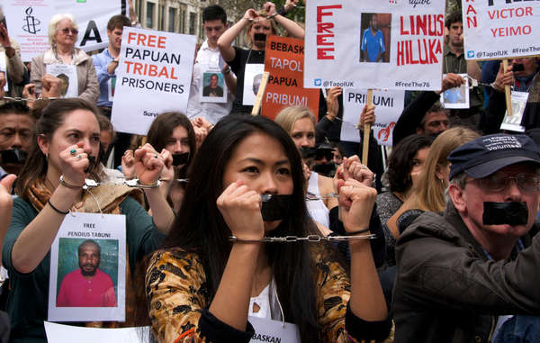 The protestors outside the Indonesian embassy were handcuffed and had their mouths taped shut.