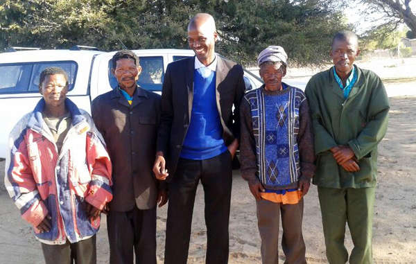 Four Bushmen stand outside court after being cleared from poaching charges, Botswana, 2014. Despite Botswana's High Court recognising the Bushmen's right to live and hunt on their ancestral land, the government has not allowed hunting licenses and continues to persecute those making attempts to feed their families by accusing them of 'poaching'.