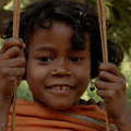 Dongria Kondh girl playing on a swing in the Niyamgiri Hills, India.
 &copy; Lewis Davids/Survival