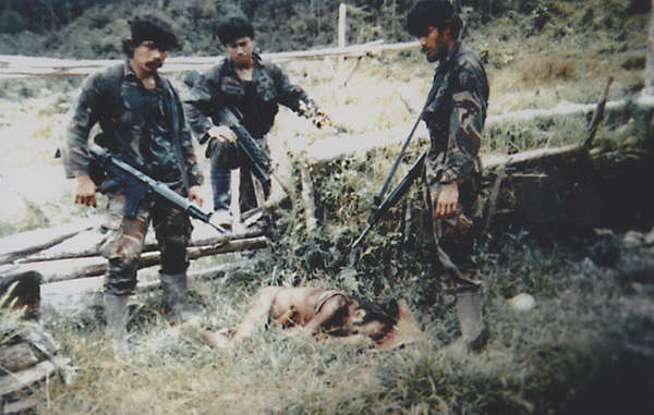For decades, West Papua’s tribal people have suffered at the hands of the Indonesian military. This 'trophy' photograph was taken by soldiers, in the same year as the Biak massacre, after they killed a man and his 12 year old nephew.