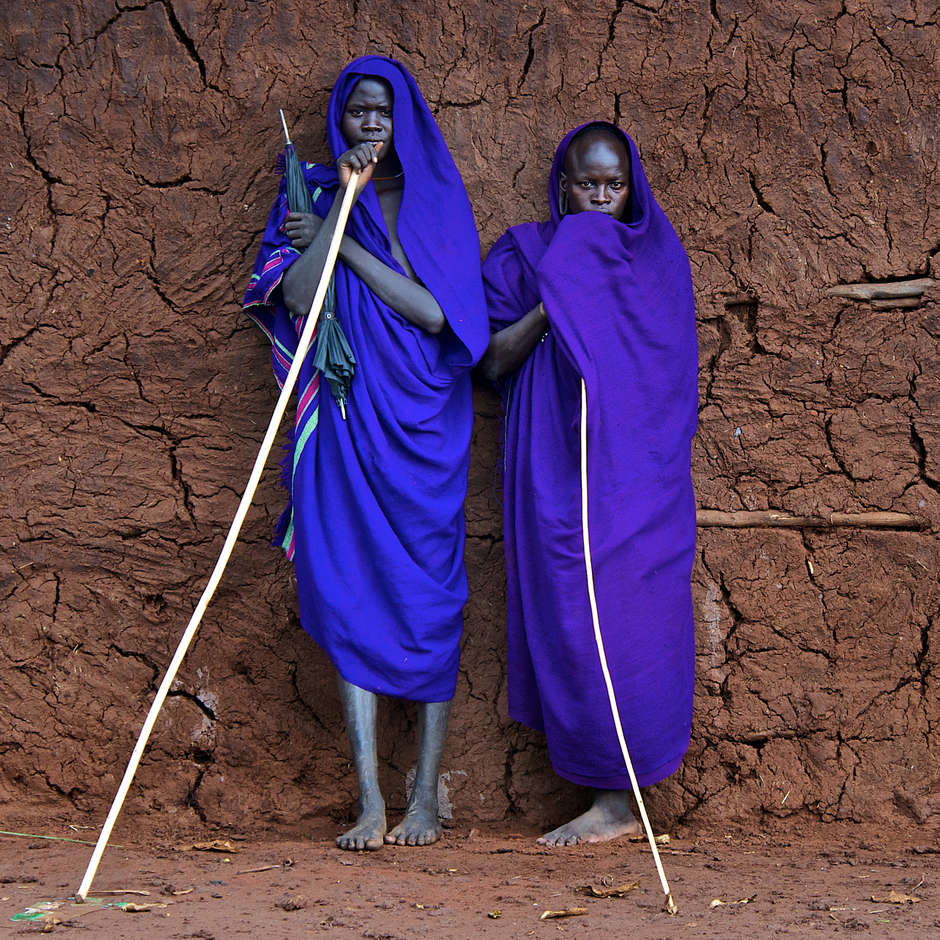 Suri, Lower Omo Valley, Ethiopia

The vibrant blue of the young Suri men’s robes stands out against a cracked earthen wall in the Omo Valley, Ethiopia.
