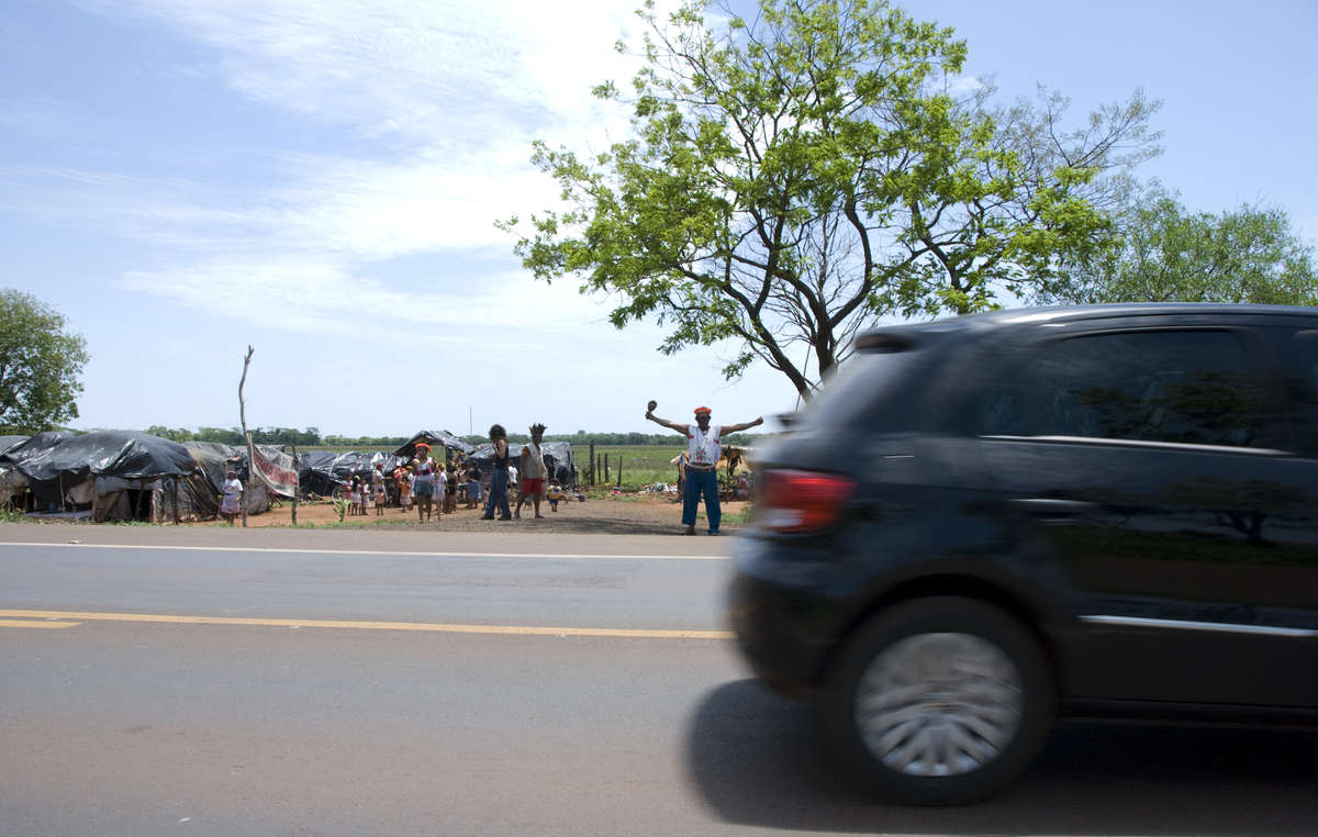 Guarani people have been forced to live by the side of the road in squalid conditions as their land has been taken illegally by cattle ranchers and sugar cane plantations.