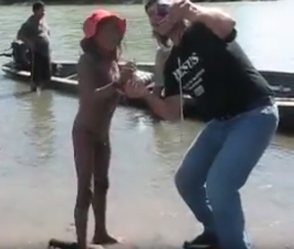 Missionaries attempting to force contact on uncontacted tribes could end up wiping them out. Here, a missionary smiles as he takes a selfie with an uncontacted child who has just emerged from the forest. This simple act could kill, as he is likely to be carrying germs of common Western diseases to which the tribespeople have no resistance.