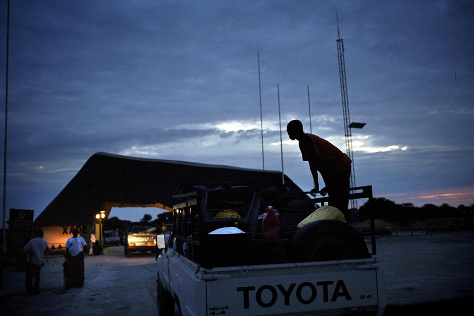 In 2002, the Bushmen took the Botswana government to court.

The case became the longest and most expensive in the country’s history, despite being brought about by its poorest inhabitants.

A historic victory was theirs in 2006.  The Bushmen won the right to return to their lands, the judges ruling that their eviction by the government was ‘unlawful and unconstitutional.'

The first convoy of Bushmen leaving New Xade in an attempt to return to the CKGR is held at the gate to the reserve by game wardens.  