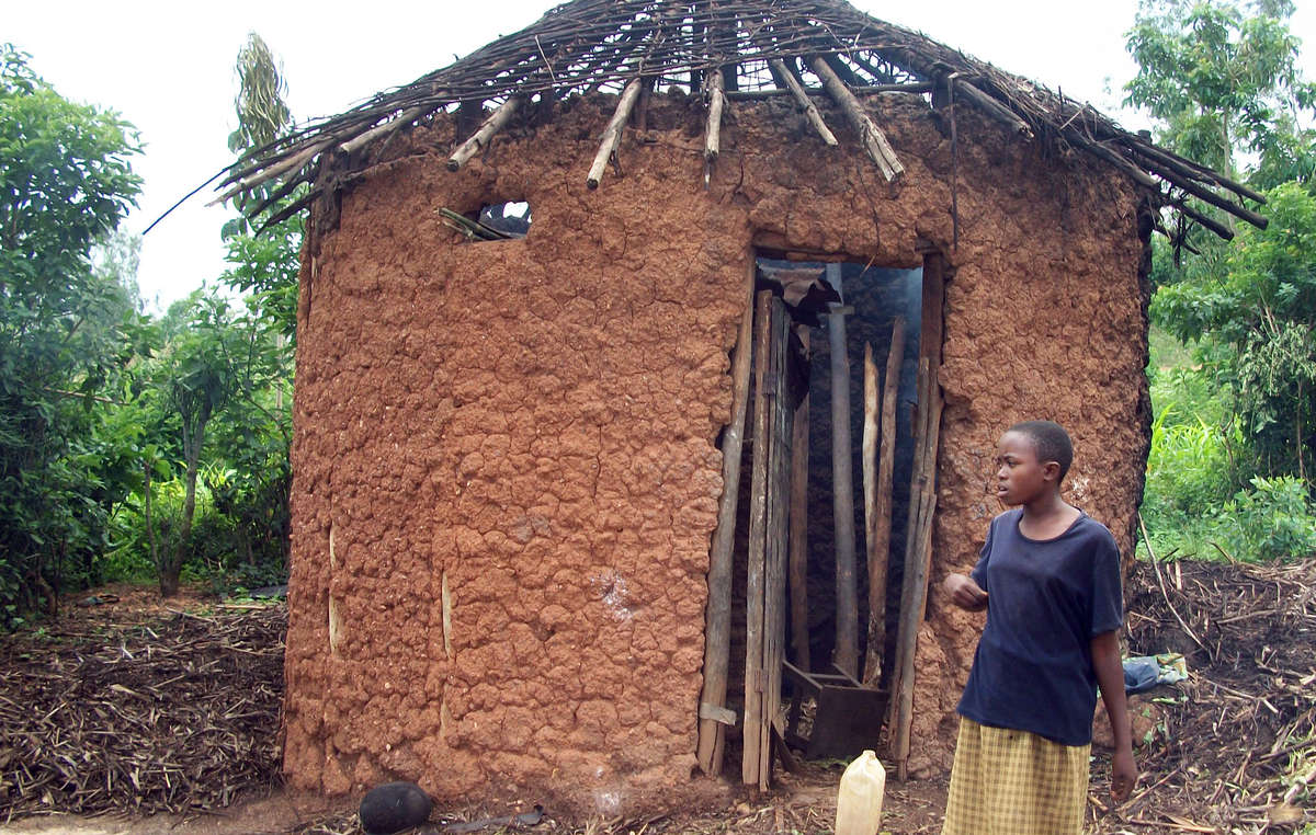 The roof of this Batwa hut was destroyed as part of a government scheme to rid Rwanda of all thatched housing. Hundreds of Batwa families have been left without shelter as a result.
