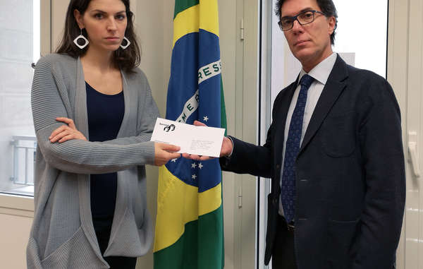 Survival protester hands in a letter to the Brazilian Consulate in Milan, Italy.