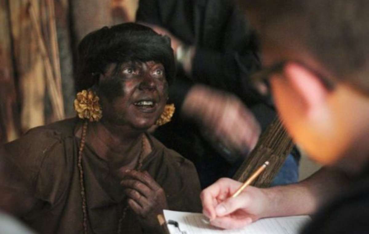 A missionary with blacked-up paint pretends to be a member of the Yanomami people during training promoted by the NTM.