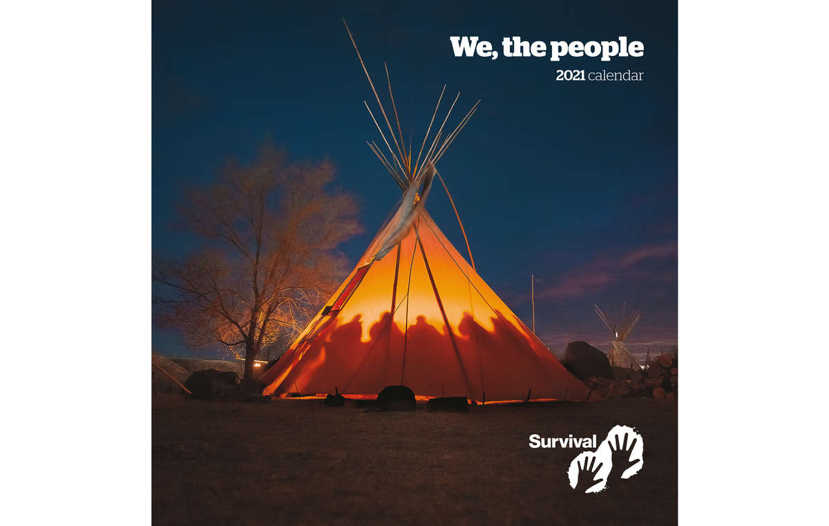 Cover of Survival's Calendar 2021. Očeti Šakówiŋ, Standing Rock, USA, 2016 – Matriarchs from various backgrounds and tribal affiliations gathered in a tipi for a women’s meeting at the resistance camp opposing the Dakota Access Pipeline in North Dakota, on the ancestral homelands of the Očeti Šakówiŋ. The day after, Morton County law enforcement attacked water and land protectors with water canons in temperatures below freezing.