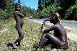 A Jarawa woman and boy by the side of the Andaman Trunk Road
