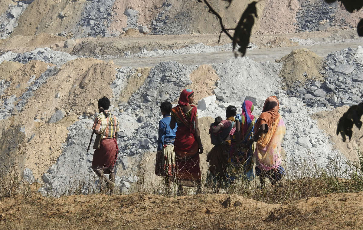 Local people look out on to the massive PEKB coal mine that has taken over their lands.