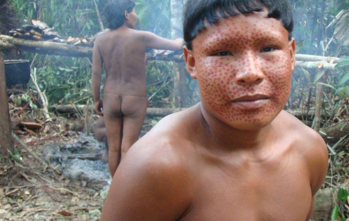 A young Suruwaha man with face paint, Brazil.