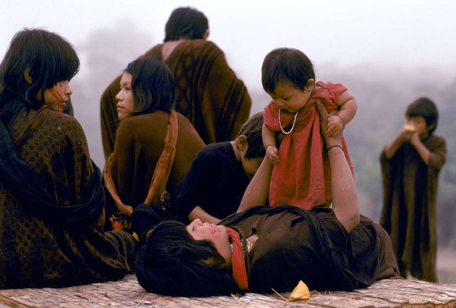 A young Ashaninka mother, wearing a traditional kushma robe, plays with her baby daughter.

Ashaninka children are given a provisional name when they start walking, and an official name at the age of seven. 

The Ashaninka believe that children can inherit the characteristics of any animal eaten by their mothers during pregnancy. Expectant mothers therefore refrain from eating turtle meat, for fear their child will be slow-moving.

During adolescence, Ashaninka girls learn to make the traditional robe, called a kushma, by spinning, dyeing and weaving wild cotton on loom. 

"Like many tribal peoples, Ashaninka have lived – and still live – in complex societies, where the solidarity of the group is of utmost importance," says Stephen Corry.
