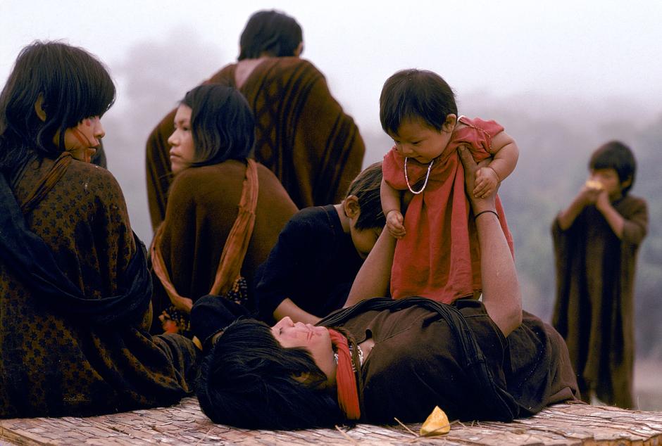 A young Asháninka mother, wearing a traditional _kushma_ robe, plays with her baby daughter in Acre state, Brazil.  

Pregnant Asháninka women refrain from eating turtle meat for fear it will make their child slow. 

Asháninka children also learn self-sufficient skills, such as hunting and fishing, at an early age.



