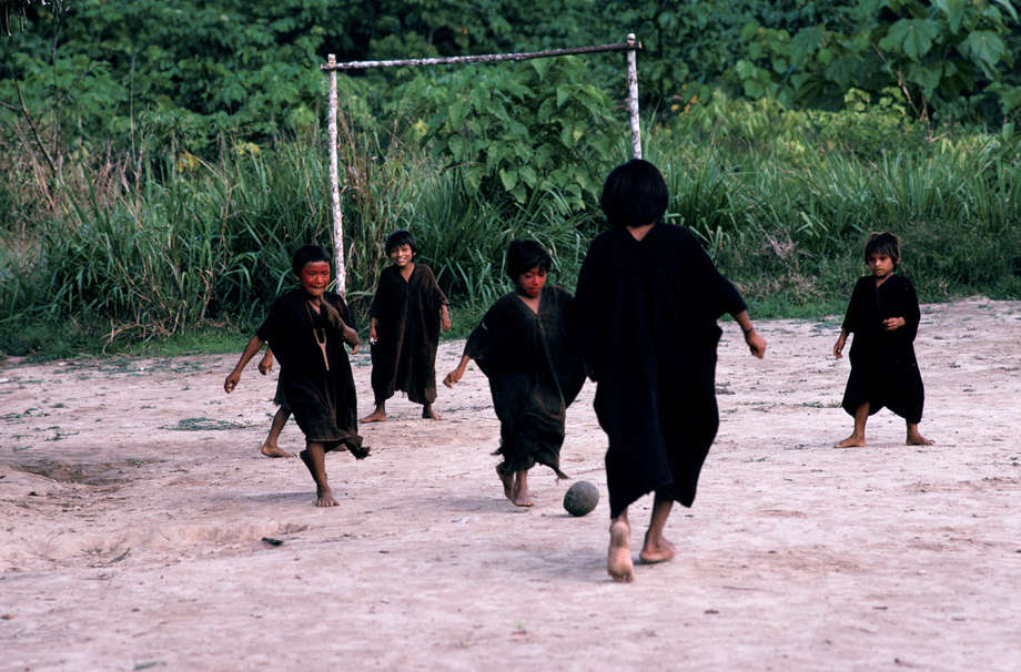 Brazilian Ashaninka children play football with a ball made of rubber tapped from trees in Acre state.


The Ashaninka children’s football is made from natural rubber; the goal posts are made from tree trunks bound with reeds.

During the rubber boom that started in the late nineteenth century, the Ashaninka in Peru were forced by European companies to work as slaves.

The search for rubber profoundly changed the history of the region and had dramatic consequences for its indigenous populations; it is thought that as much as 80% of the Ashaninka population died from disease, exhaustion and massacres.

"When the West began its marriage to the motor car, its love letters were written in Indian blood," says Stephen Corry.
