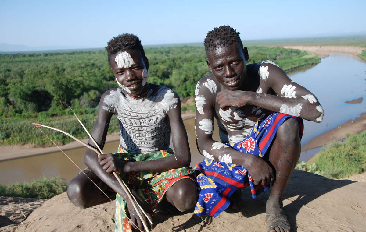 Two Karo boys in front of a full Omo River. Water levels are now unrecognizably low.