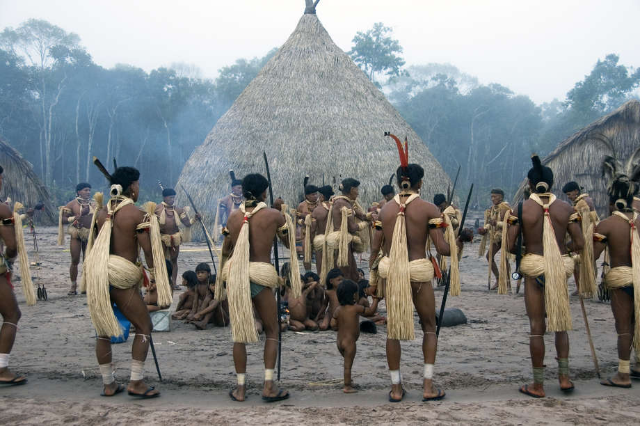 The climax of the festival is a lavish banquet during which salt, manioc and honey are exchanged with the _yakairiti_ spirits.

The men's waists are wrapped in palm fibres, their necklaces strung with red macaw, curassow and hawk feathers. They move around a circle in slow steps, their chanting accompanied by the deep piping of bamboo flutes.

For the last few years however, the tribe has struggled to carry out _Yãkwa_, due to the decline in fish stocks from deforestation and hydro-electric dam construction. The UN body UNESCO recently called for the _urgent safeguarding_ of the _Yãkwa_ ritual,  referring to it as an _intangible cultural heritage_.
 
_When I was a small boy, I always came to the dams with my father_, said Kawari, an Enawene Nawe elder. 

_We let the fish go up the river to lay their eggs. But if hydro-electric dams are built all the eggs will disappear and the fish will die_. 