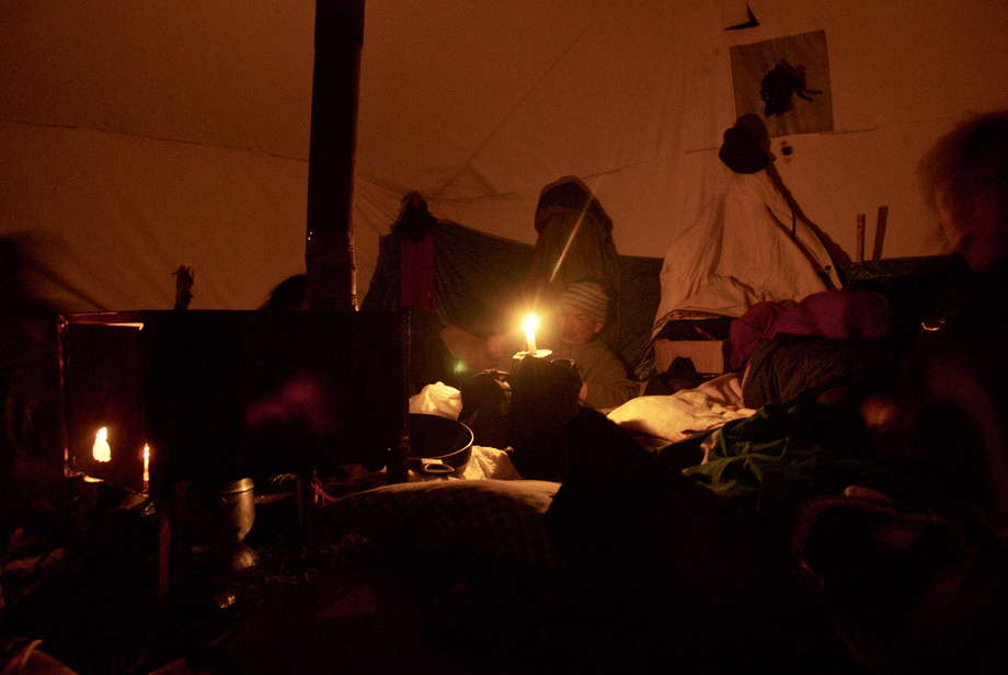 Inside a traditional Innu tent, a sheet-metal stove is stoked throughout the night with dry juniper wood.

Spruce boughs, arranged in an intricate overlapping pattern on the floor, provide insulation against the cold. 

