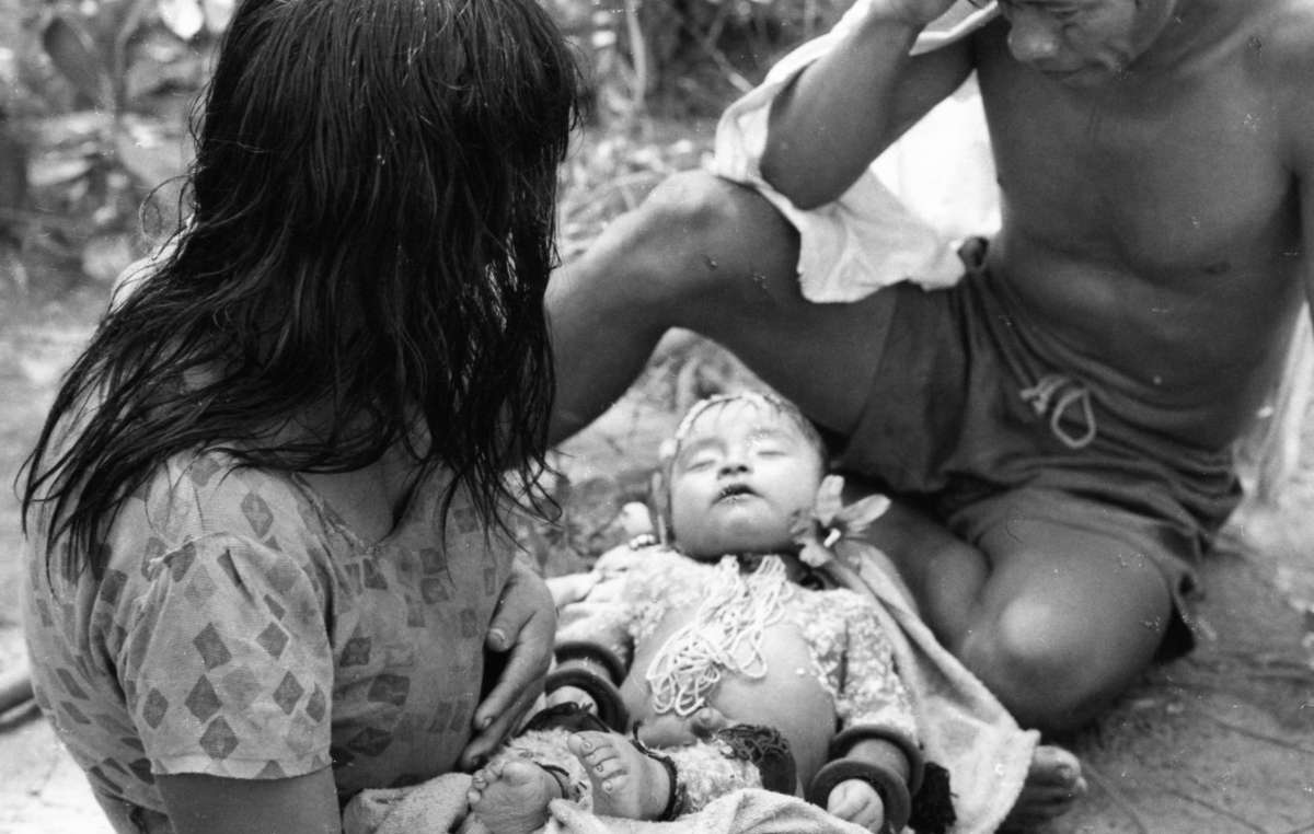 A Karajá couple with their baby, who has died of flu, Brazil.