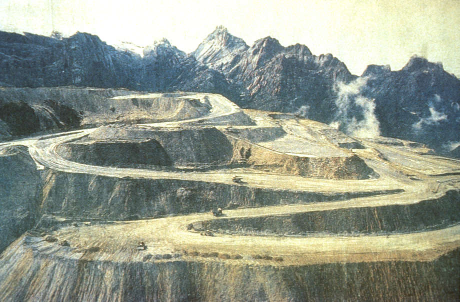 In West Papua, the largest gold and copper mine in the world, operated by the American company Freeport McMoRan, has devastated the land of the highland Amungme tribe, destroying the sacred mountain they know as 'Mother'.  

Many Amungme have been killed by Indonesian soldiers in the process of defending the mine. 

_The reason why the Amungme people are working really hard to protect their land is because they believe the mountain area is their mother's head_, say the tribe. _So now they are gouging out our mother's brains_.