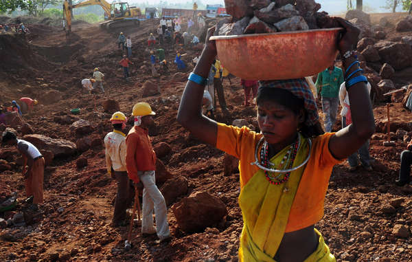 The fate that could await many Baiga threatened with illegal eviction: a Baiga woman works for a pittance in a bauxite mine.