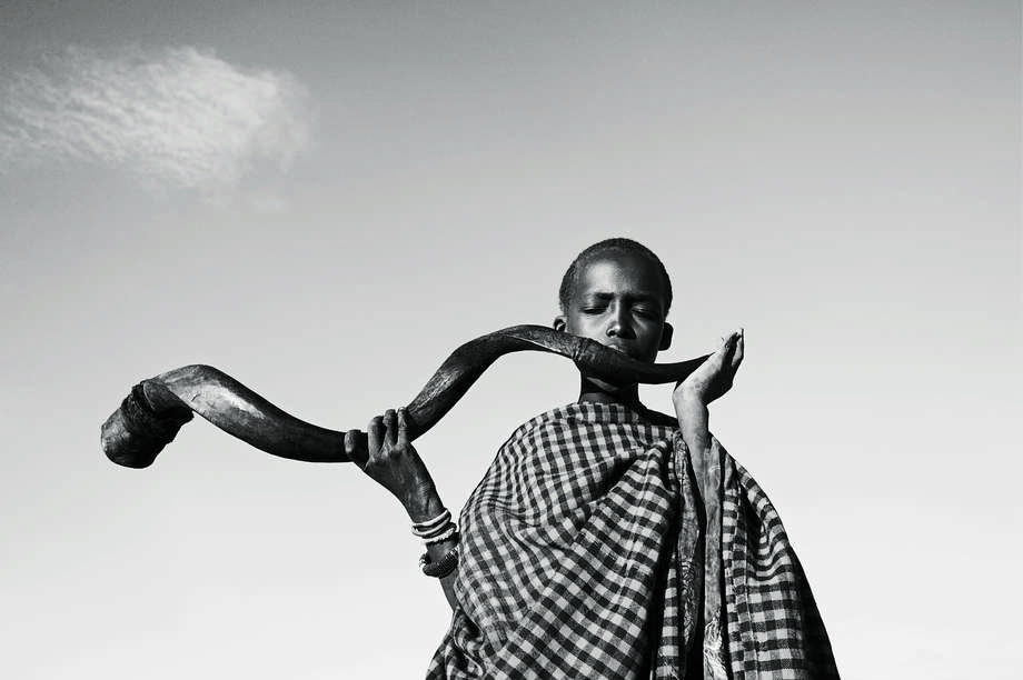 Tribal festivals also honor the different cycles of human life.  

In East Africa, a young Maasai boy blows into the spiraling horn of a greater kudu antelope to summon _morans_ for the _e unoto_ ceremony, which heralds the transition of the teenage _moran_ into manhood. 

The ceremony involves several days of singing and dancing.
