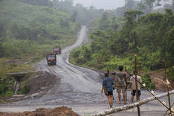 Penan armed with blowpipes block road as Shin Yang logging trucks approach.